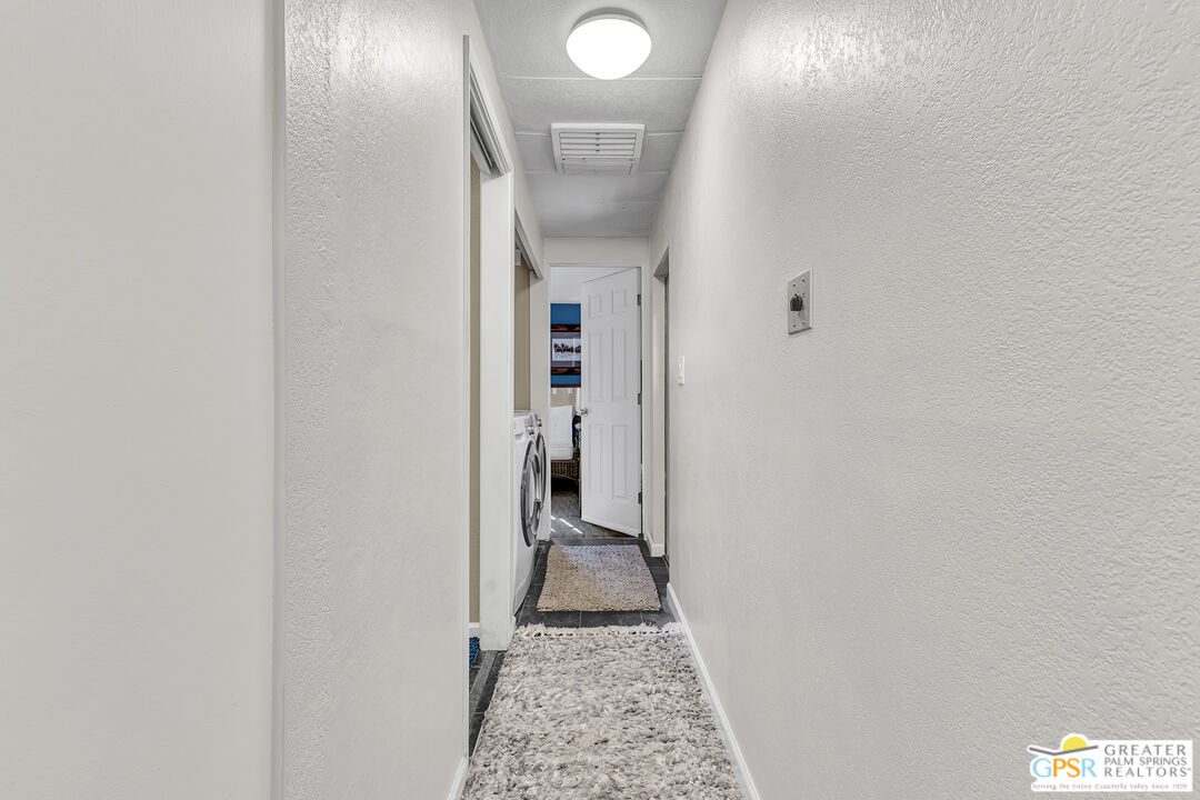 25955 Highway 243, Unit 18 Idyllwild, CA 92549 - Photo 30 of 43 a view of a hallway with wooden floor and a bathroom