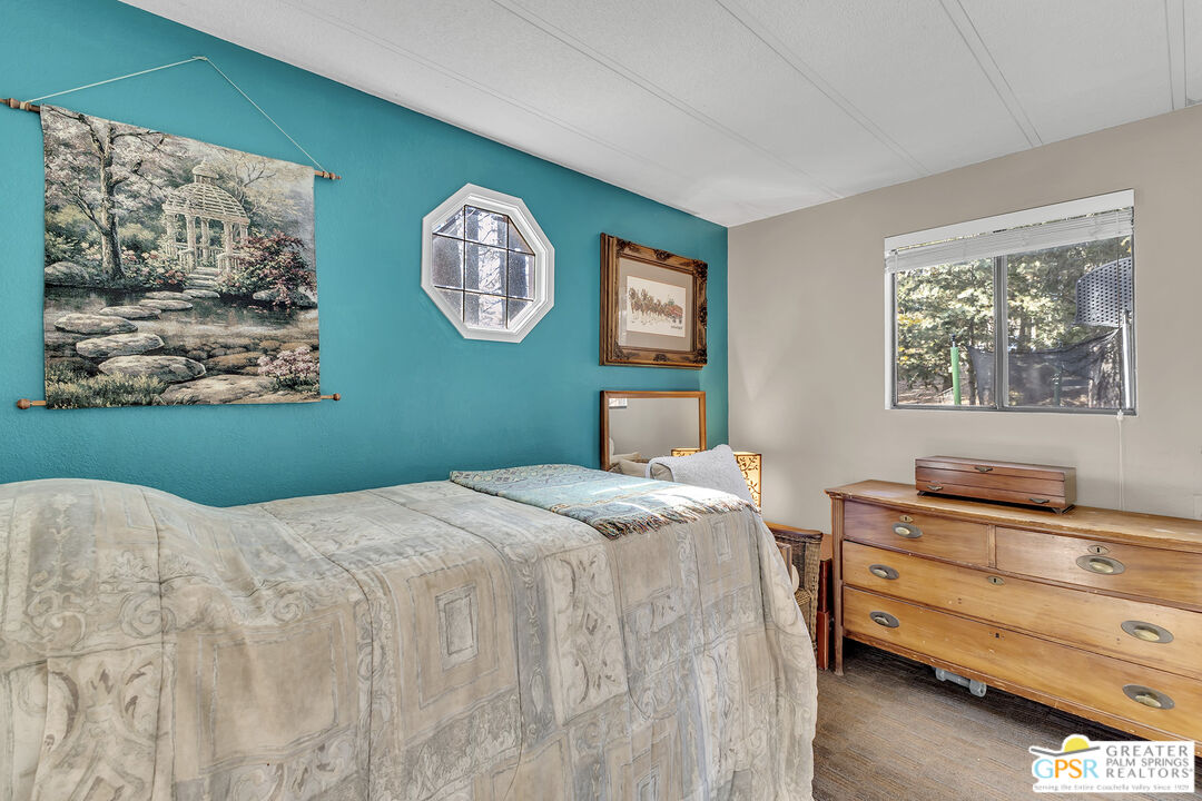 25955 Highway 243, Unit 18 Idyllwild, CA 92549 - Photo 33 of 43 a bedroom with a bed and a dresser