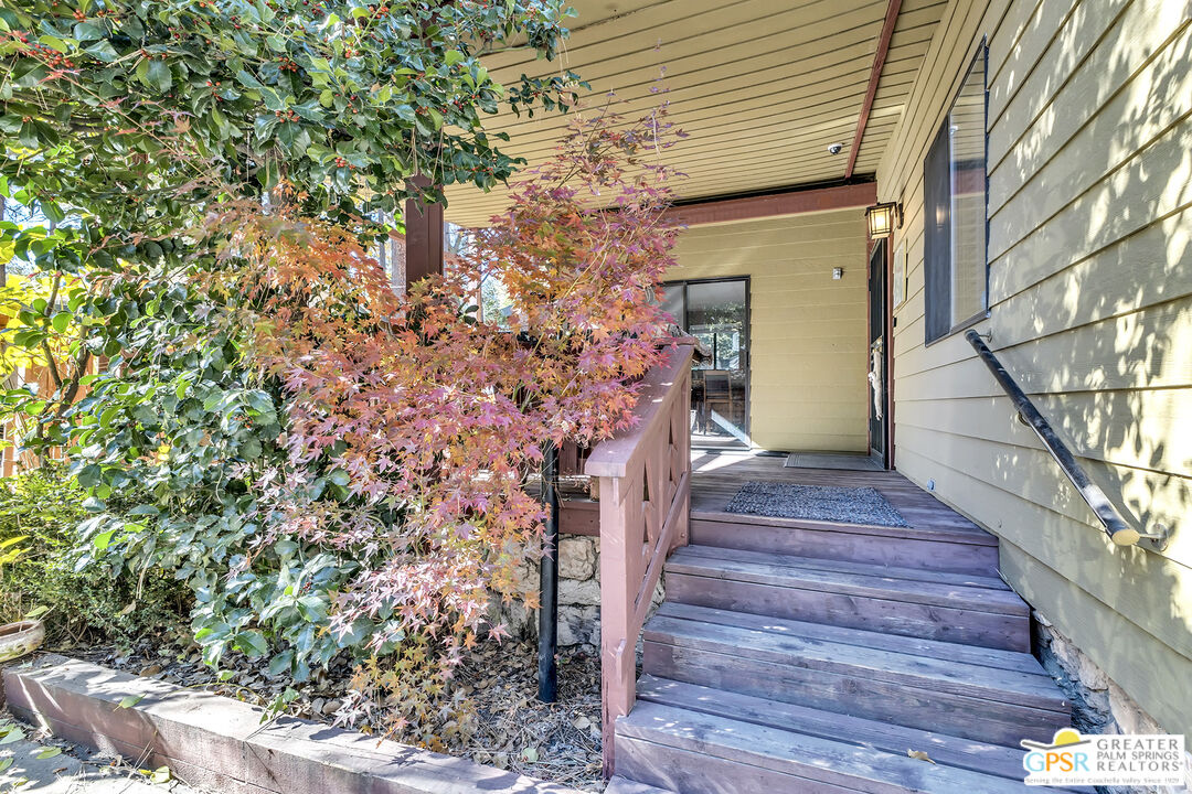 25955 Highway 243, Unit 18 Idyllwild, CA 92549 - Photo 7 of 43 a front view of a house with wooden stairs and potted plants