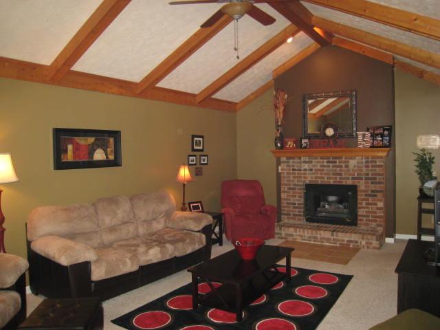 436 Calista Road White House, TN 37188 - Photo 2 of 16 HUGE living room with palladium window, vaulted ceiling, ceiling fan and brick fireplace