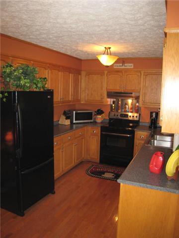 436 Calista Road White House, TN 37188 - Photo 7 of 16 Large kitchen with hardwood flooring, abundance of cabinets.