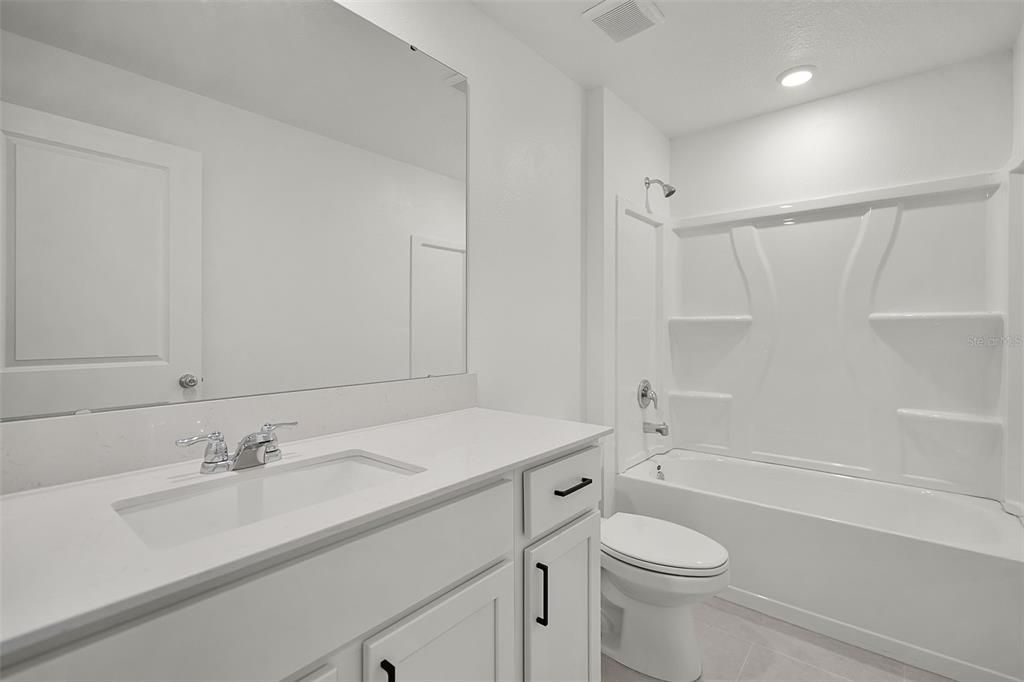 2110 Lasso Loop Eagle Lake, FL 33839 - Photo 15 of 33 a bathroom with a sink toilet vanity and shower