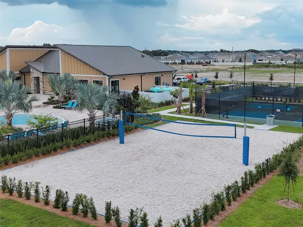 a view of a house with a yard and potted plants