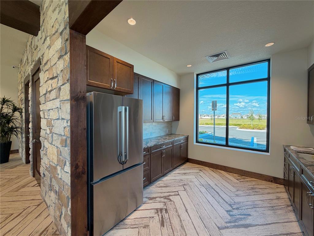 2110 Lasso Loop Eagle Lake, FL 33839 - Photo 27 of 33 a kitchen with stainless steel appliances granite countertop a refrigerator and a sink