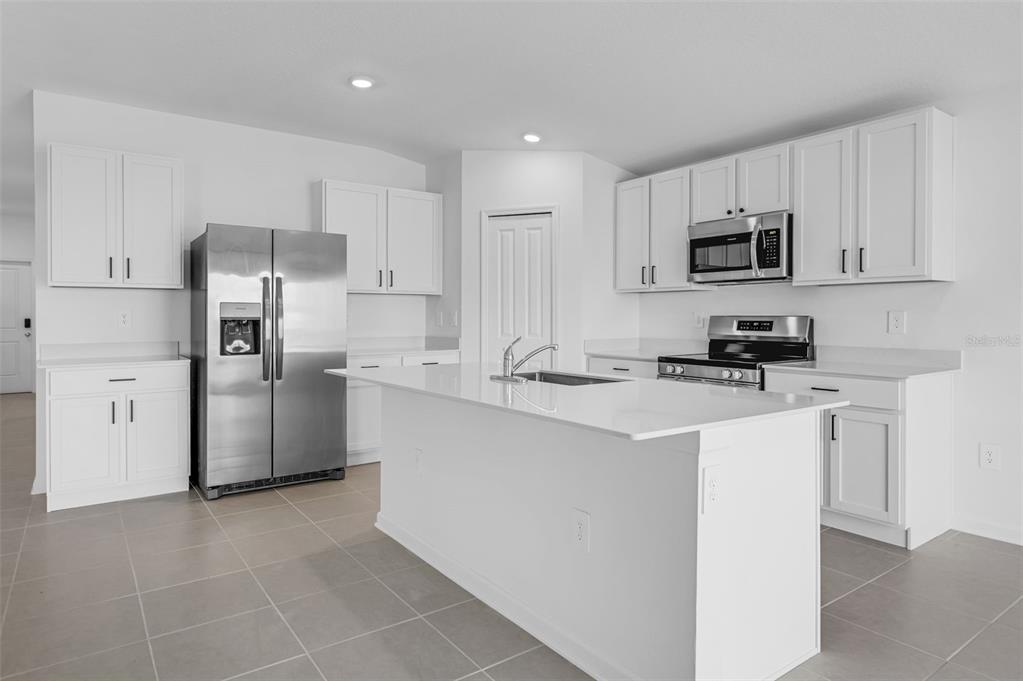 2110 Lasso Loop Eagle Lake, FL 33839 - Photo 3 of 33 a kitchen with stainless steel appliances a refrigerator sink and microwave