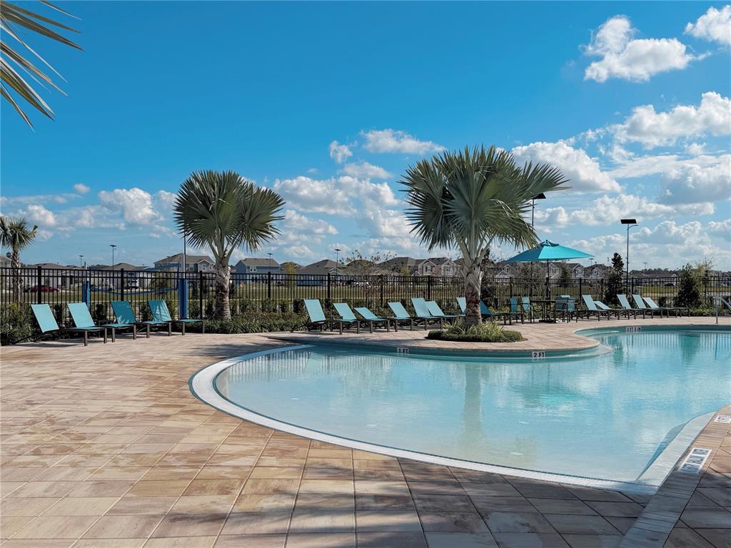 2110 Lasso Loop Eagle Lake, FL 33839 - Photo 32 of 33 a view of a swimming pool with a table and chairs