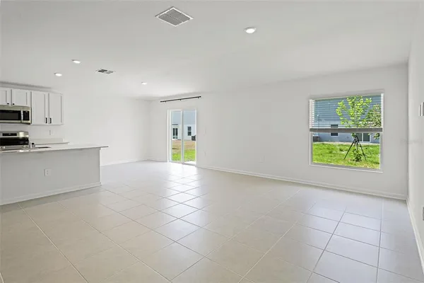 a view of a kitchen with an empty space and a window