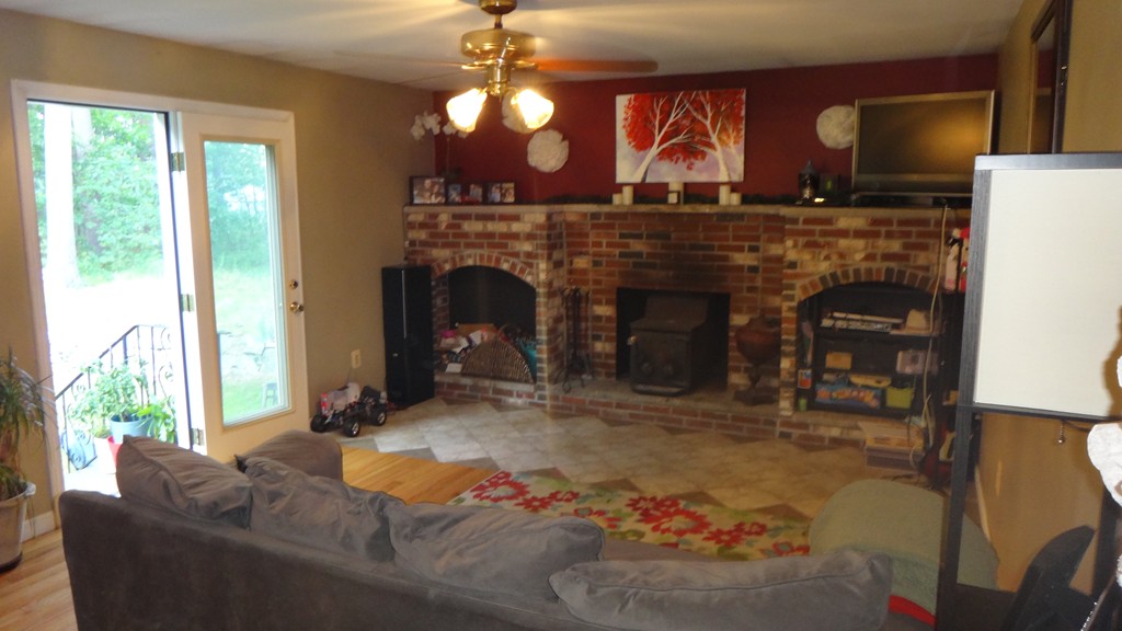 269 Dunstable Road Tyngsborough, MA 01879 - Photo 2 of 11 a living room with furniture and a fireplace