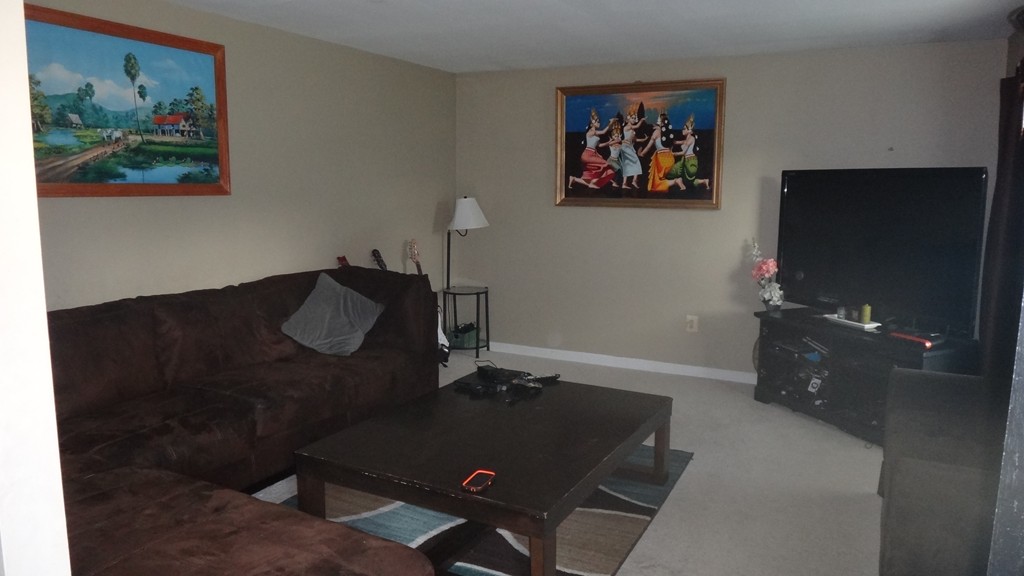 269 Dunstable Road Tyngsborough, MA 01879 - Photo 4 of 11 a living room with furniture and a flat screen tv