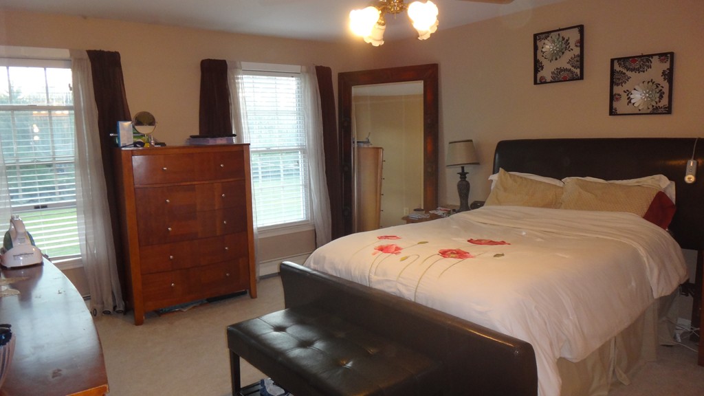 269 Dunstable Road Tyngsborough, MA 01879 - Photo 5 of 11 a bedroom with a bed and a dresser