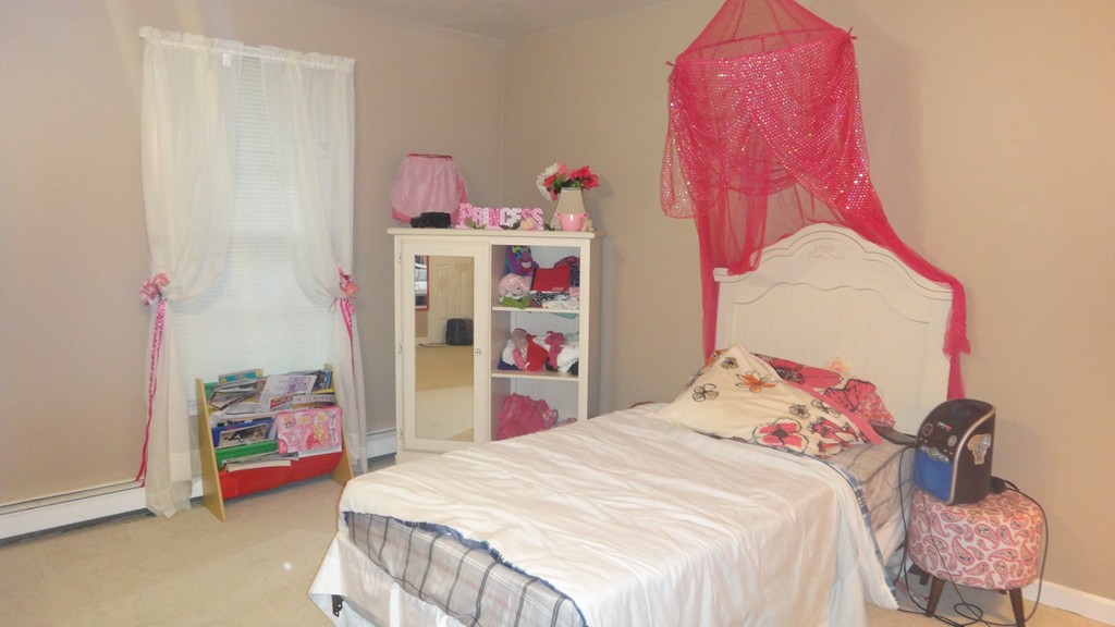 269 Dunstable Road Tyngsborough, MA 01879 - Photo 8 of 11 a bedroom with a bed and a couch