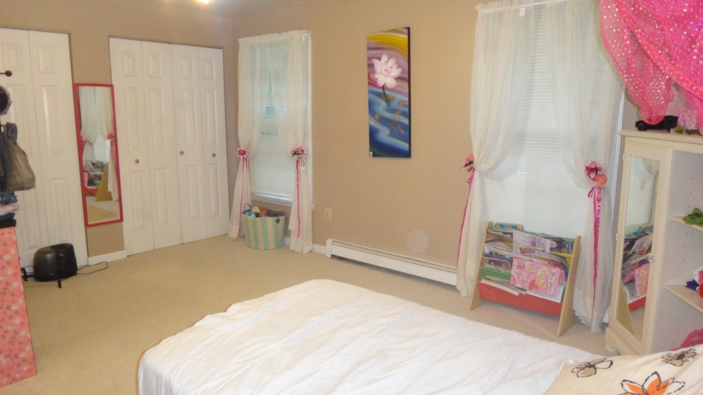 269 Dunstable Road Tyngsborough, MA 01879 - Photo 9 of 11 a bedroom with a bed and a couch