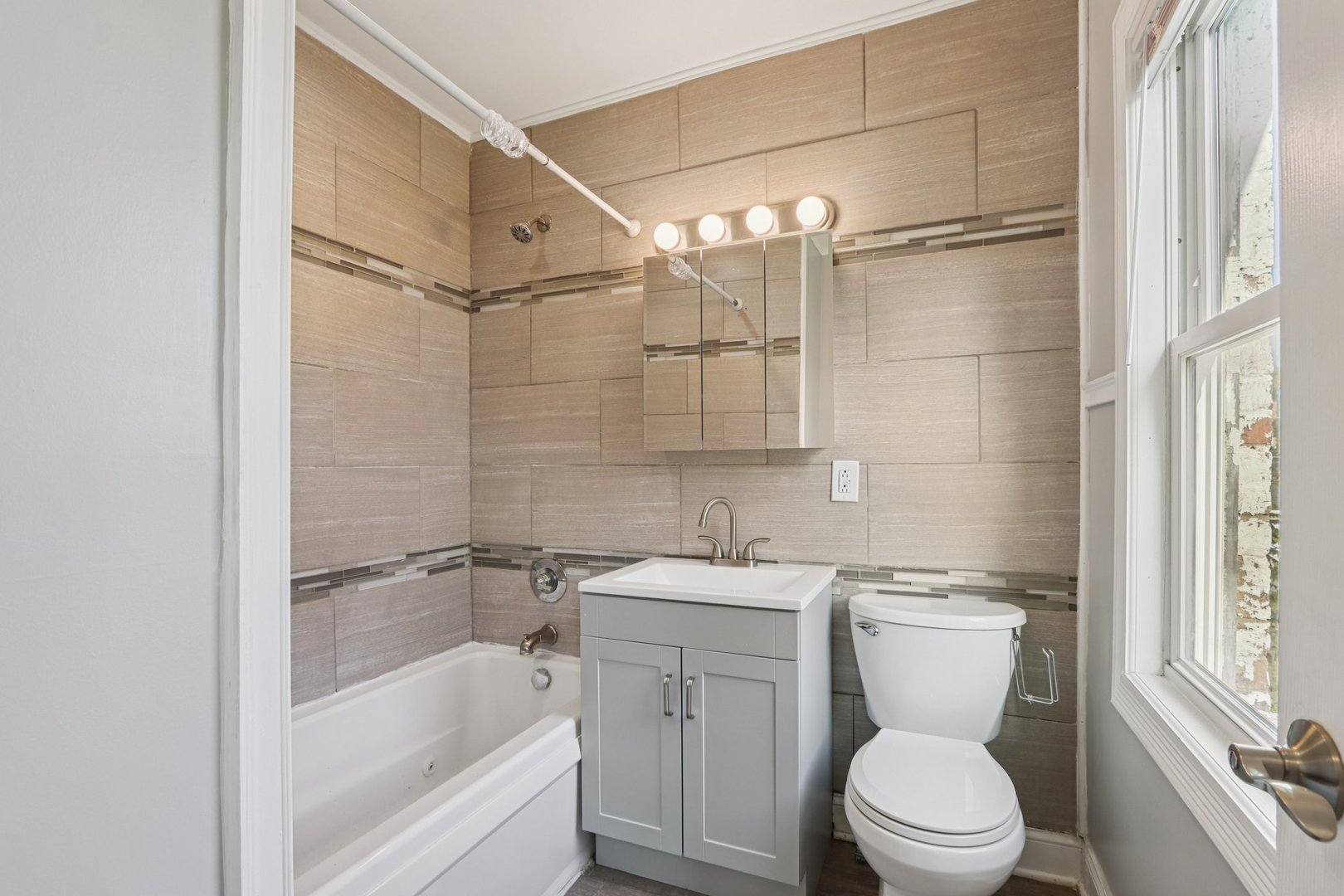 1336 East 73rd Street Chicago, IL 60619 - Photo 11 of 32 a bathroom with a sink toilet and shower