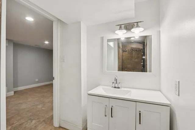 a view of a small space with wooden floor and a window