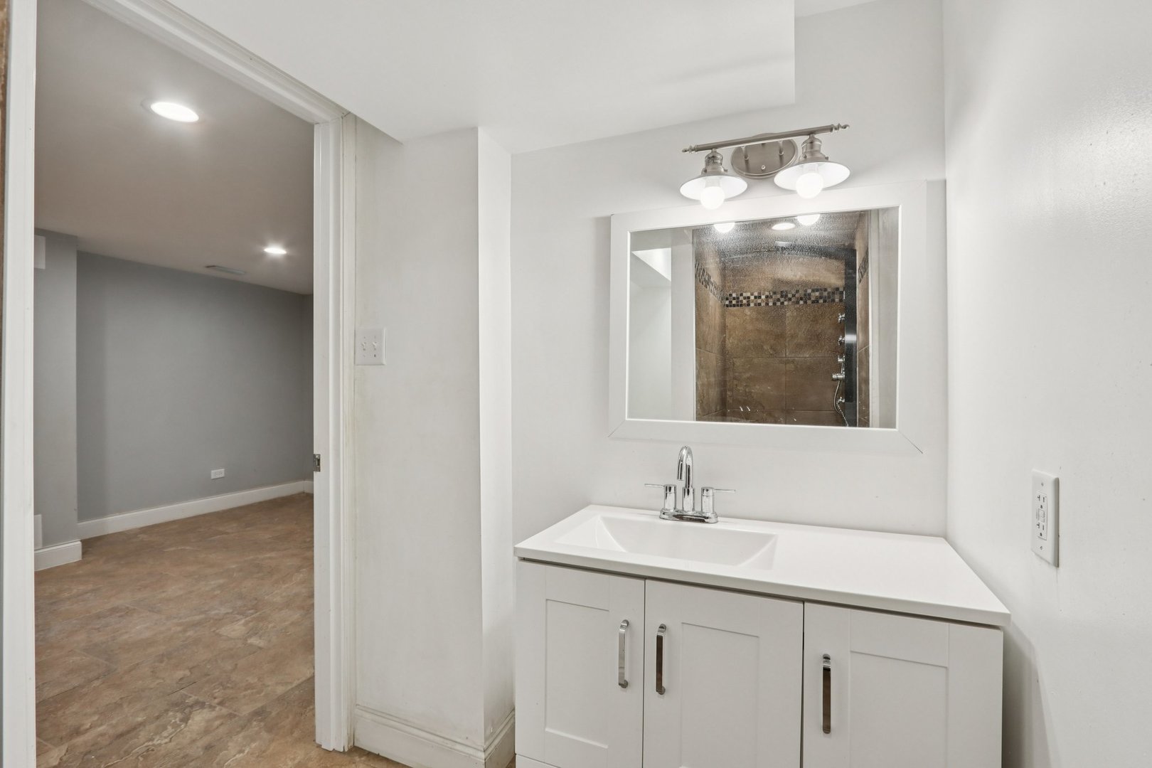 1336 East 73rd Street Chicago, IL 60619 - Photo 23 of 32 a bathroom with a sink and a mirror