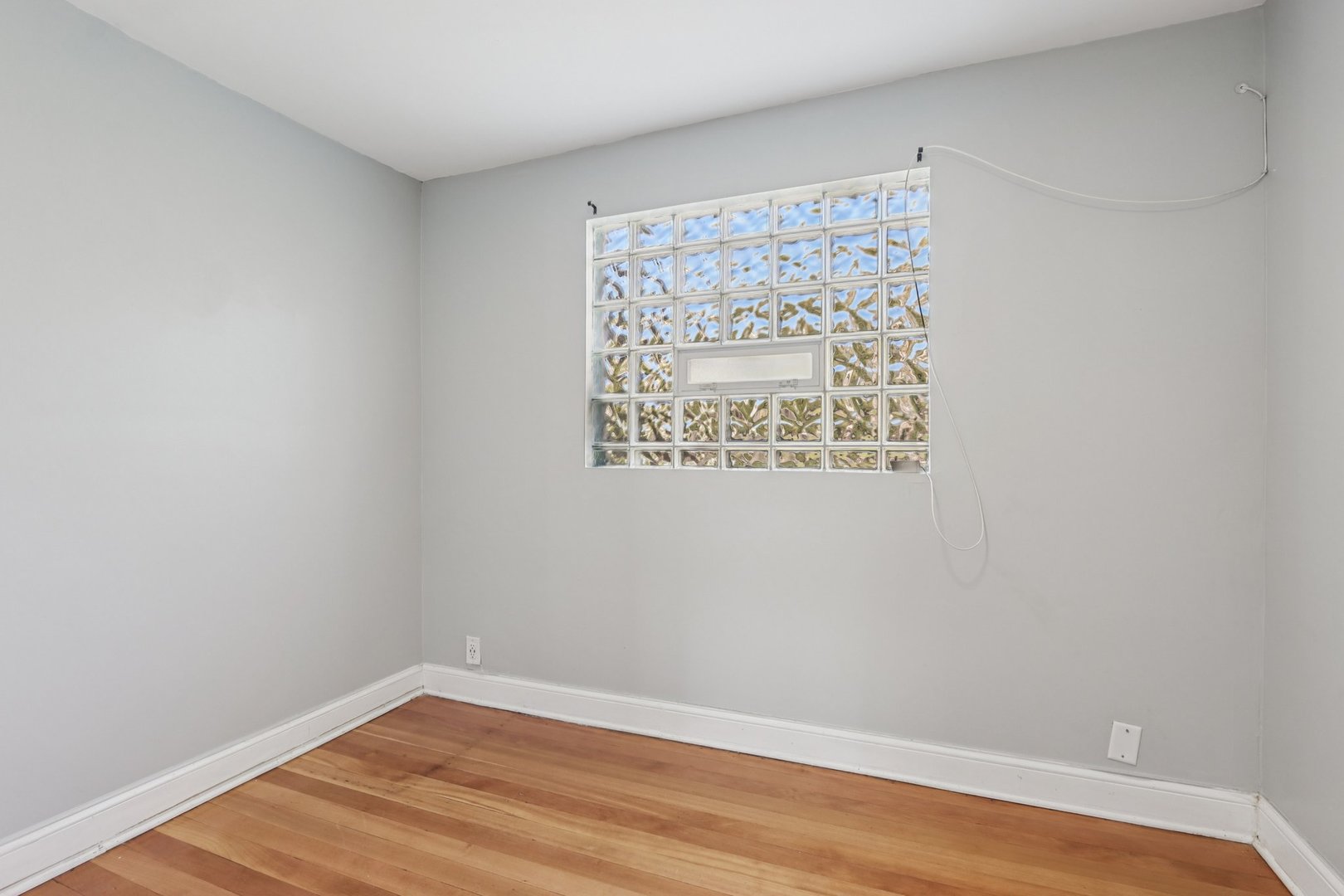 1336 East 73rd Street Chicago, IL 60619 - Photo 24 of 32 a view of a small space with wooden floor and a window