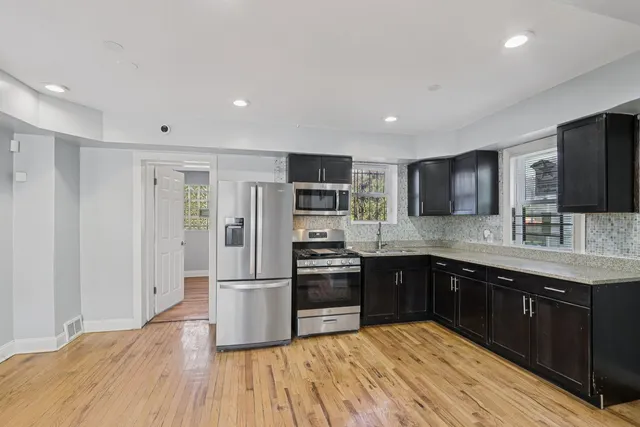a large kitchen with cabinets and stainless steel appliances