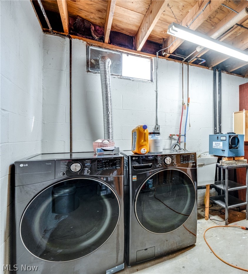 151 Meadowridge Road Mogadore, OH 44260 - Photo 19 of 26 Laundry area with unfinished concrete floors and separate washer and dryer