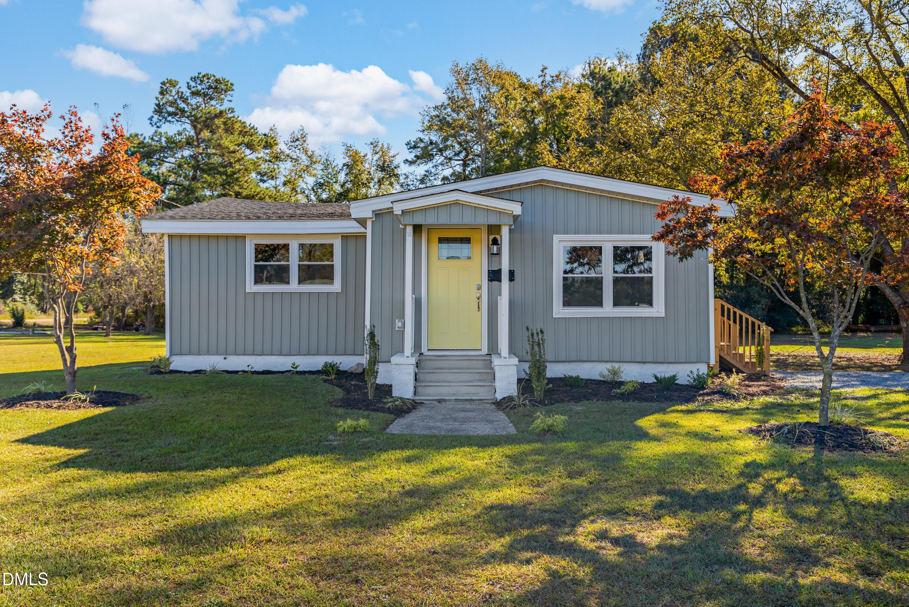 a view of a house with swimming pool and sitting area