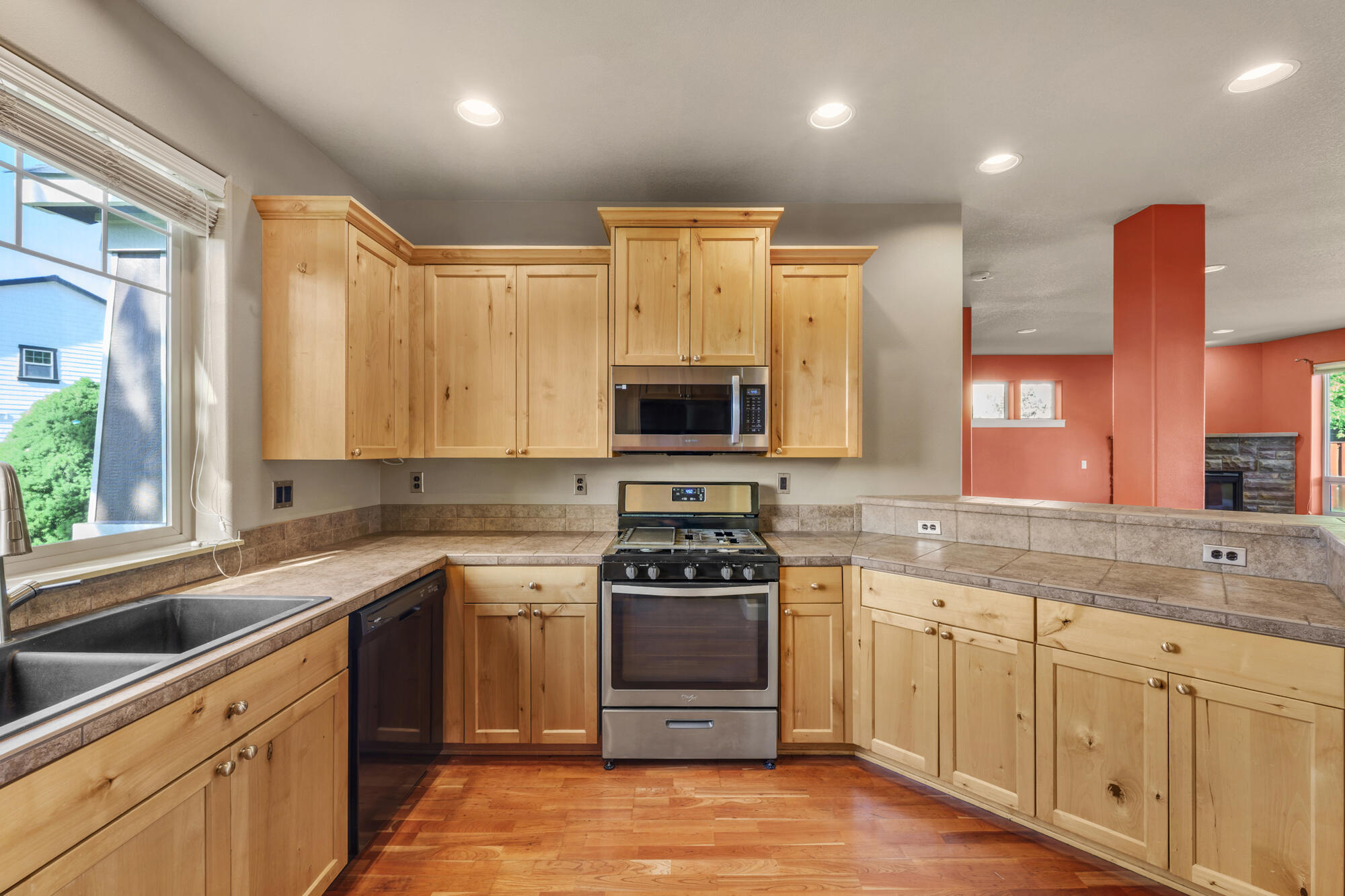 1402 Northeast Hudspeth Road Prineville, OR 97754 - Photo 12 of 36 a kitchen with stainless steel appliances granite countertop a sink a stove and a refrigerator
