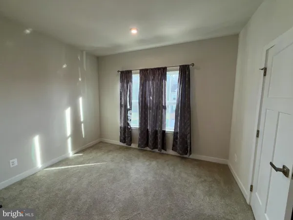 an empty room with entrance and windows