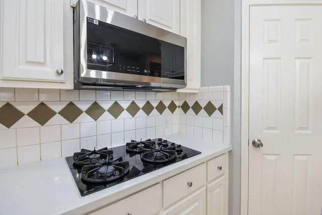 a view of washer and dryer with kitchen in the background