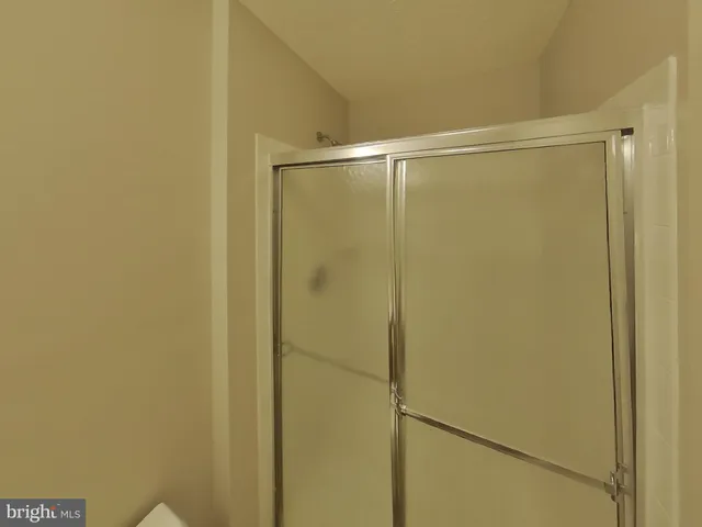 a bathroom with a glass shower door