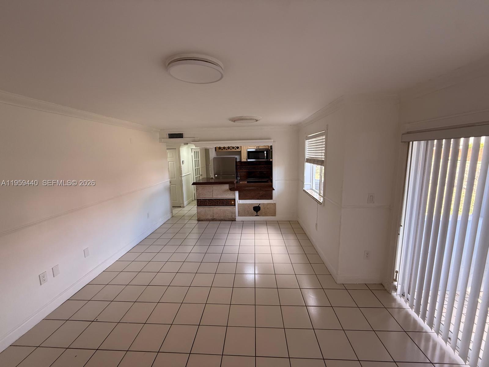 6205 Southwest 131st Court, Unit 104 Miami, FL 33183 - Photo 12 of 21 a view of an empty room with a window