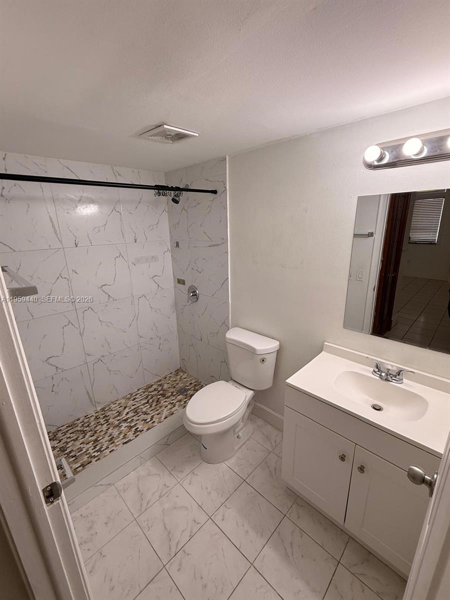 6205 Southwest 131st Court, Unit 104 Miami, FL 33183 - Photo 14 of 21 a bathroom with a sink toilet and shower