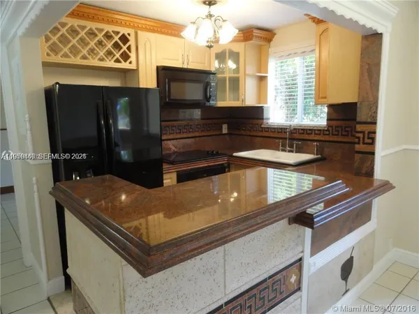 a kitchen with stainless steel appliances granite countertop a sink and a microwave
