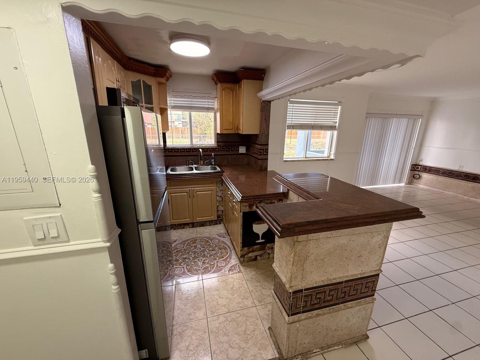 6205 Southwest 131st Court, Unit 104 Miami, FL 33183 - Photo 10 of 21 a kitchen with stainless steel appliances granite countertop a sink a stove a refrigerator a window