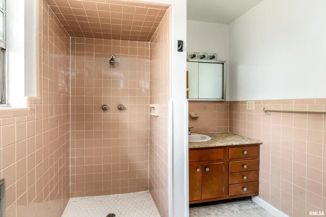 a bathroom with a granite countertop sink and mirror