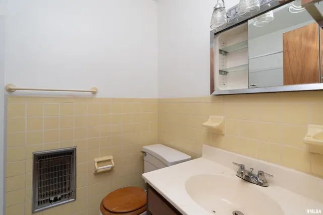 a bathroom with a sink a toilet and mirror