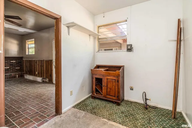 a view of an entryway with wooden floor and a cabinet