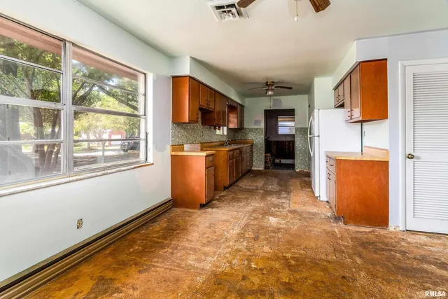 a kitchen with stainless steel appliances granite countertop a refrigerator and a stove top oven