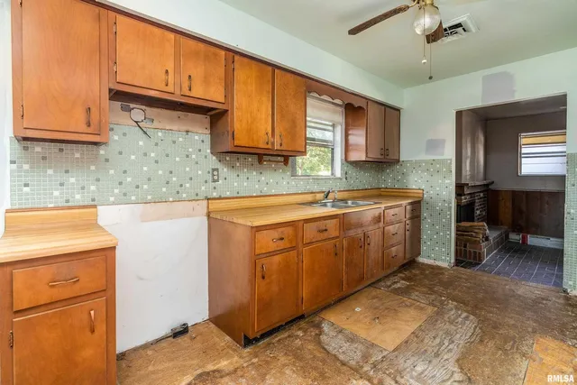 a kitchen with a sink stove and cabinets