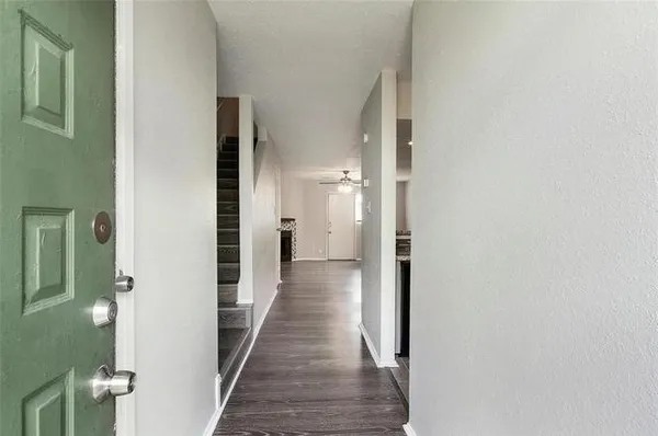 a view of a hallway with a wooden floors