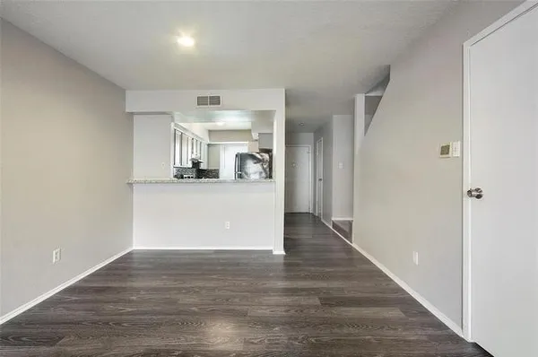 a view of a kitchen cabinets and wooden floor