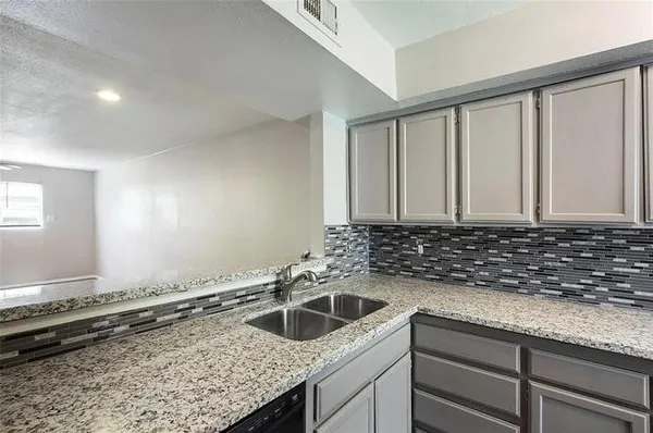 a kitchen with a sink and cabinets