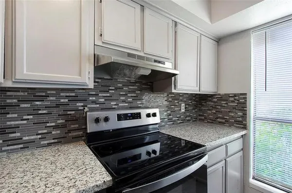 a kitchen with stainless steel appliances granite countertop a stove and a microwave