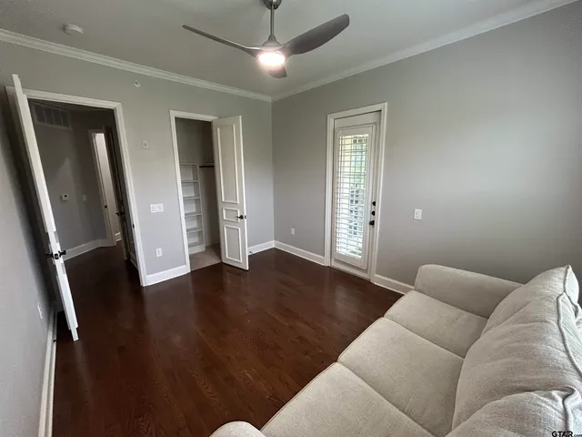 a living room with furniture and a hard wood floor