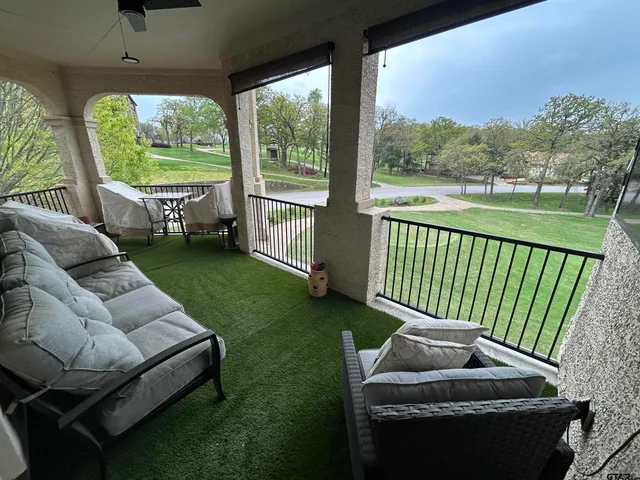 a view of a patio with couches chairs and a yard