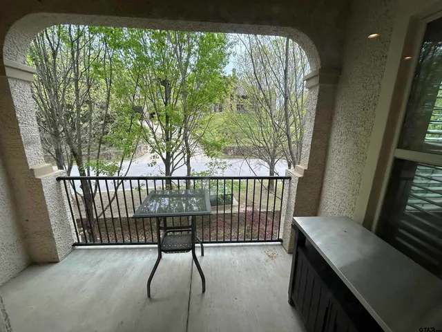 a view of balcony and yard