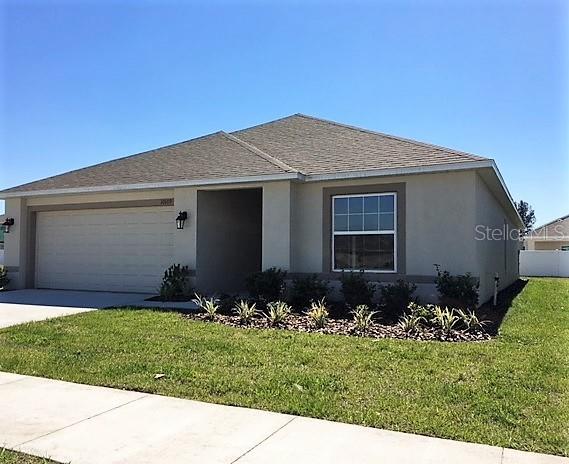 10109 Carp Hollow Road Sun City Center, FL 33573 - Photo 1 of 1 a front view of house with a garden