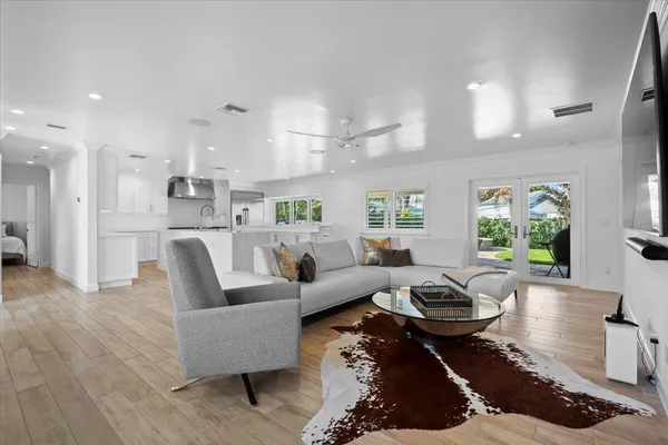 a living room with furniture and a wooden floor