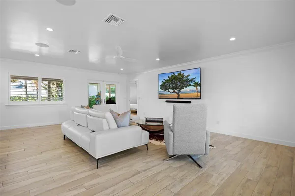 a kitchen with stainless steel appliances kitchen island granite countertop a table chairs sink refrigerator and cabinets