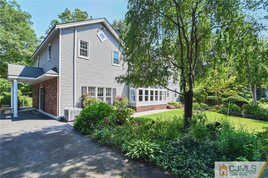 59 Spring Hill Road Old Bridge, NJ 07747 - Photo 1 of 24 a view of a house with yard and a garden