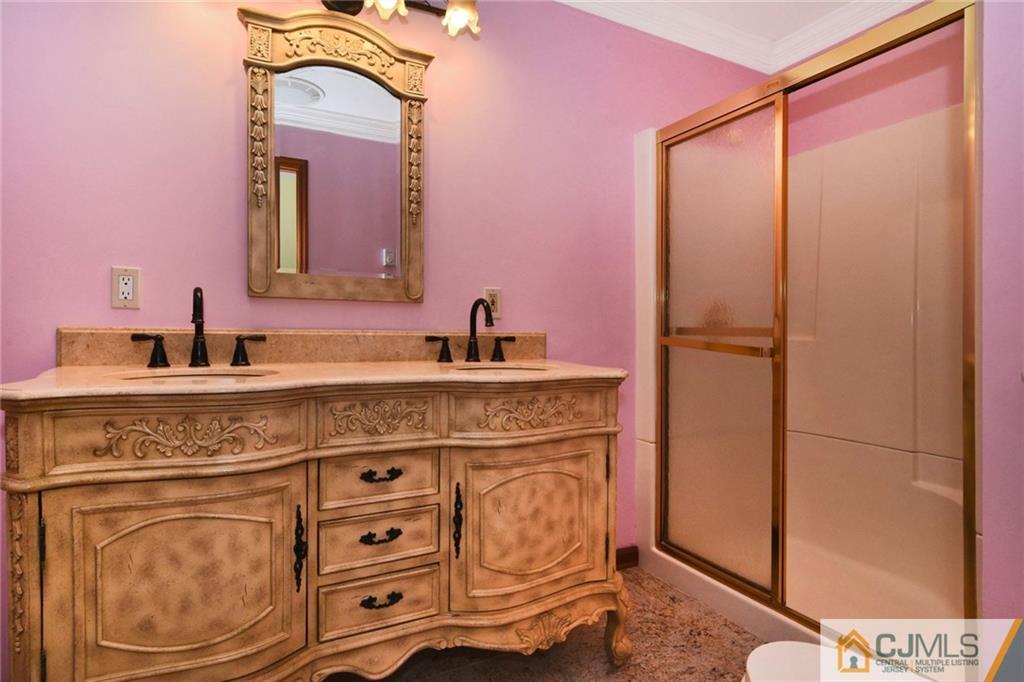 59 Spring Hill Road Old Bridge, NJ 07747 - Photo 19 of 24 a bathroom with a sink a vanity and a mirror