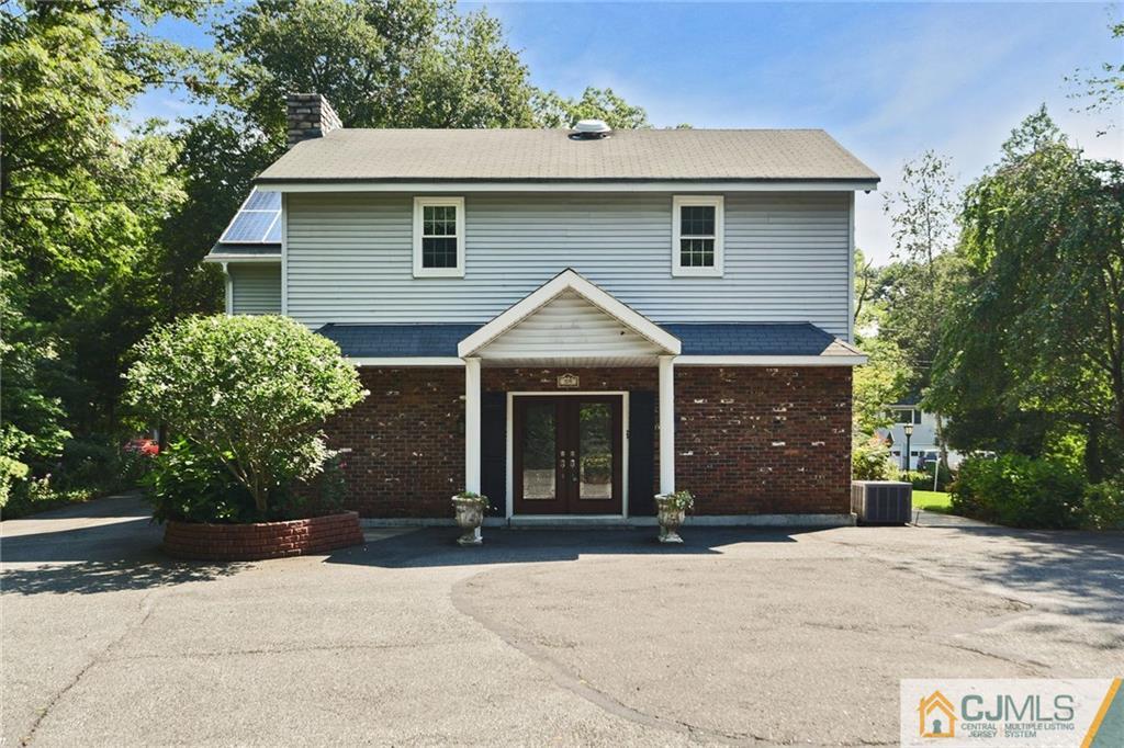 59 Spring Hill Road Old Bridge, NJ 07747 - Photo 3 of 24 a front view of a house with a yard and a garage