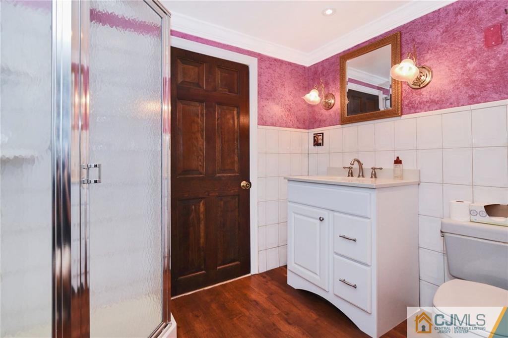 59 Spring Hill Road Old Bridge, NJ 07747 - Photo 22 of 24 a bathroom with a sink and a mirror
